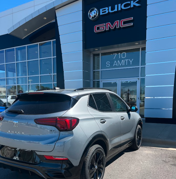 Silver Buick SUV parked in front of Crain Buick GMC in Conway, Arkansas, with dealership signage visible